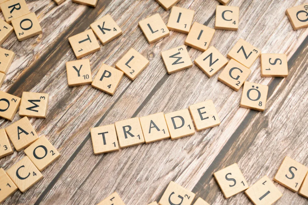 trade and trade related words on wooden table