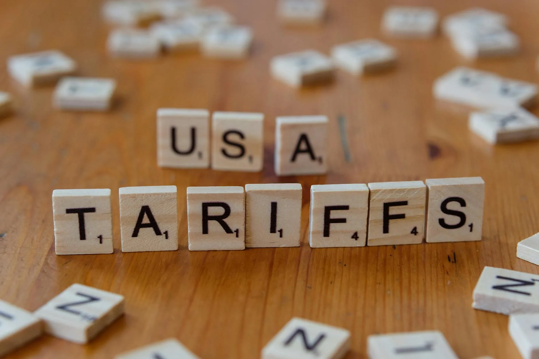 President Trump Signals Major Tariffs on Drugs, Semiconductors, and Copper 1 Your Pulse on Stocks, Finance, Markets & the Global Economy usa tariffs concept with scrabble tiles