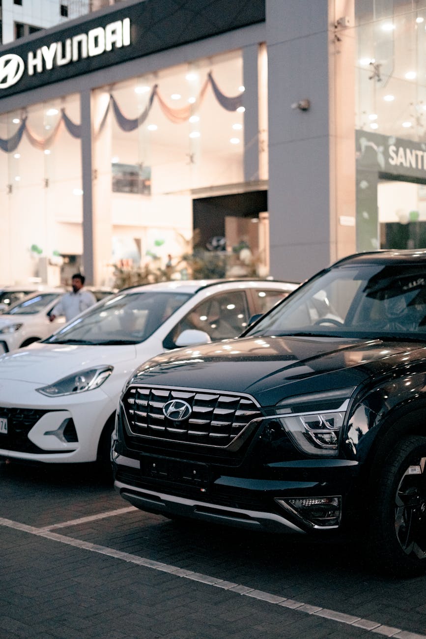 photo of new cars parked in front of a car dealership