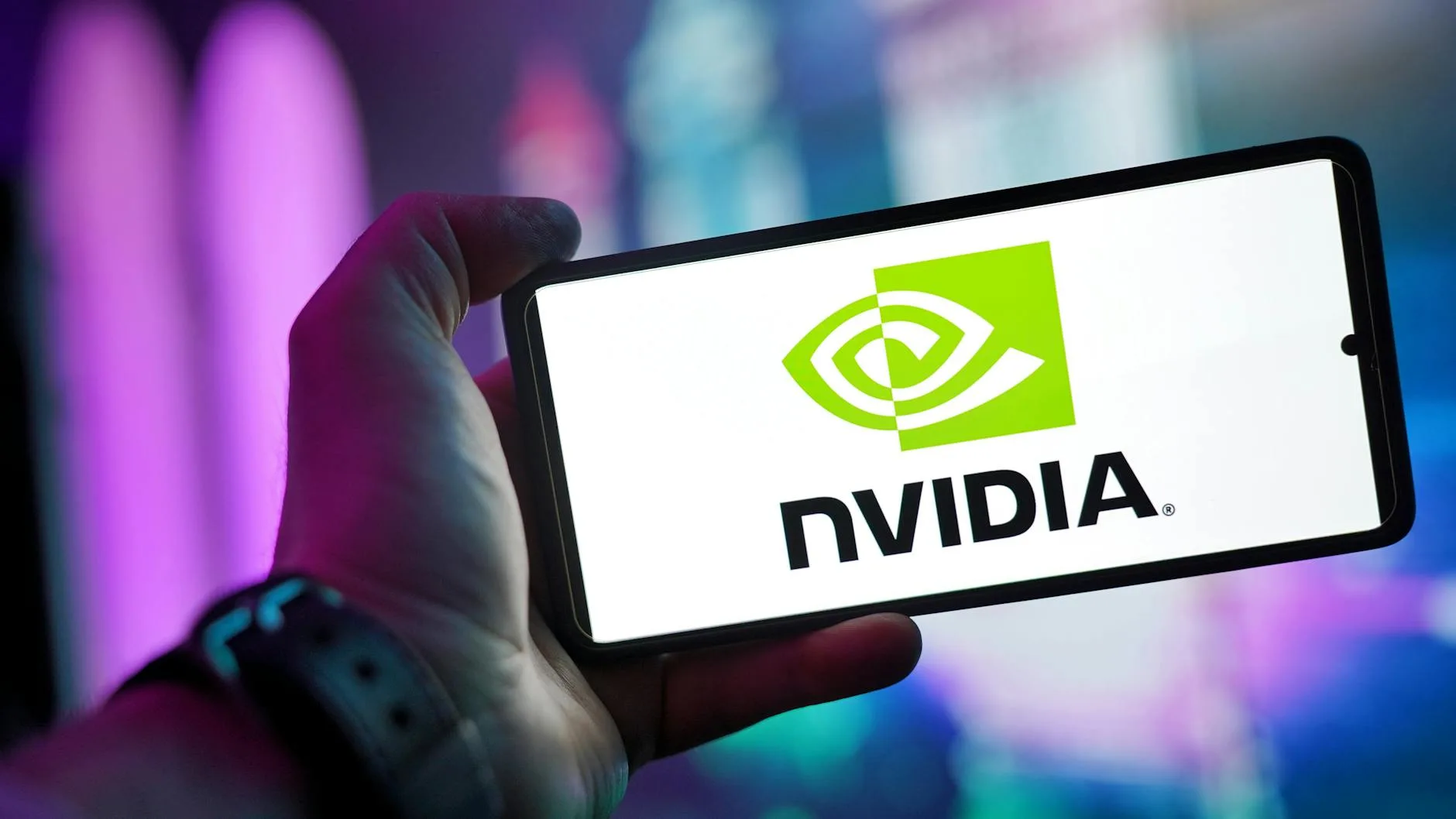 Nvidia Loses Entire China AI Chip Market Due to US Trade Ban 1 Your Pulse on Stocks, Finance, Markets & the Global Economy person holding smartphone displaying nvidia logo