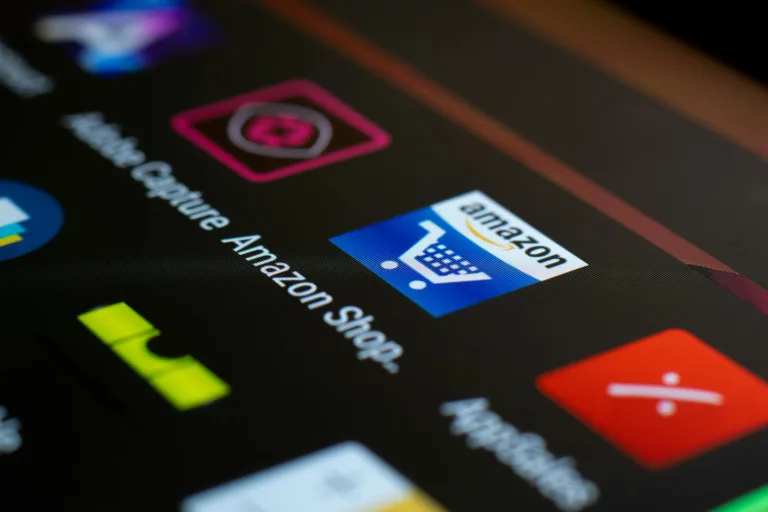 Amazon to Cut 30,000 Corporate Jobs and Boost AI Automation by 2027 close up of smartphone screen with icons