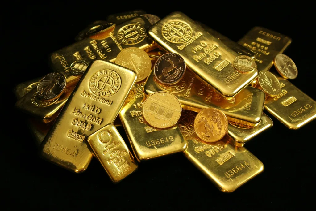 gold coins and bars on black background