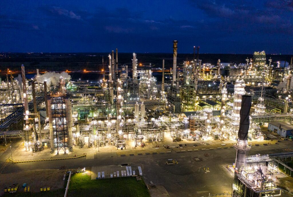 aerial view of an industrial plant with lights turned on during night time