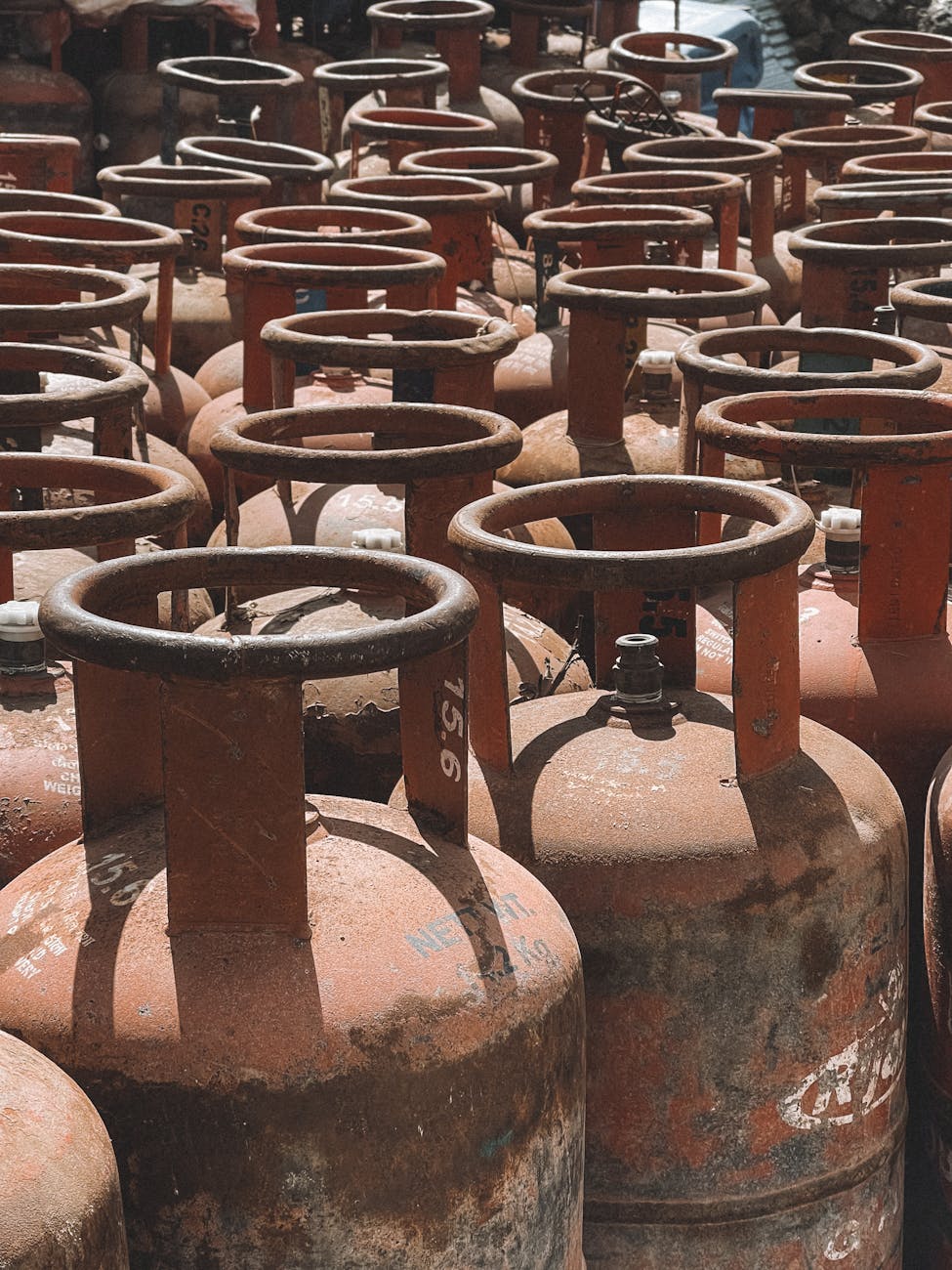 rows of rusty gas cylinders in nepal