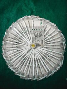 round silver coin on paper money