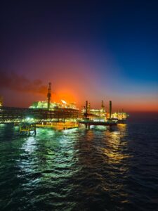dramatic offshore oil rig at sunset